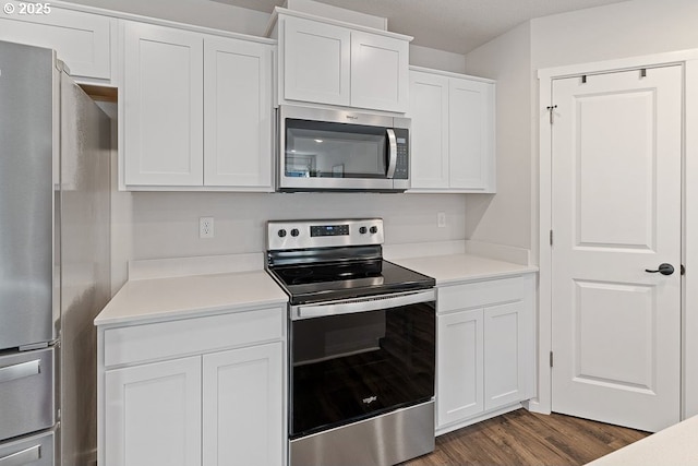 kitchen featuring stainless steel appliances, dark hardwood / wood-style floors, and white cabinets