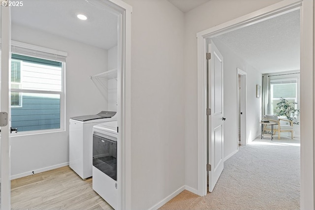 laundry room featuring washing machine and dryer and a textured ceiling