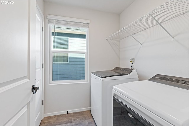 laundry room with washing machine and dryer and hardwood / wood-style floors