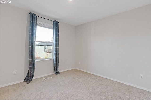 empty room with light colored carpet