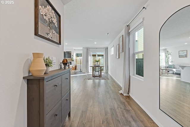 corridor featuring hardwood / wood-style floors and a textured ceiling