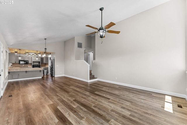 15263 Oceanview Dr, Brookings, OR 97415 - unfurnished living room with lofted ceiling, dark wood finished floors, stairway, and ceiling fan