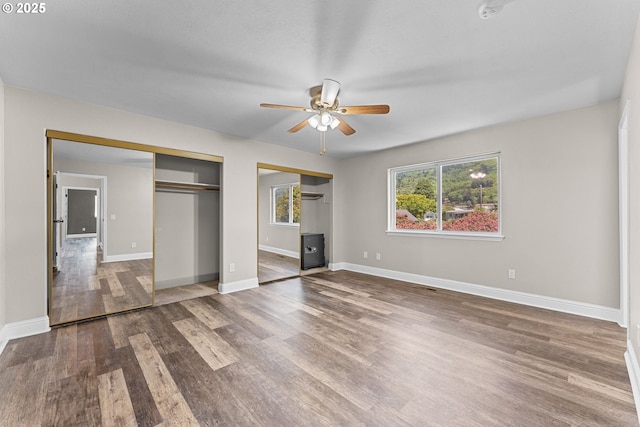 15263 Oceanview Dr, Brookings, OR 97415 - unfurnished bedroom with two closets, wood finished floors, and ceiling fan