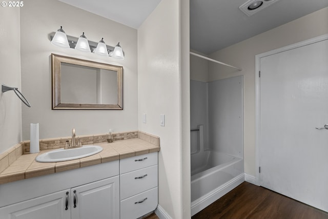 15263 Oceanview Dr, Brookings, OR 97415 - bathroom with wood finished floors, vanity, and bathtub / shower combination