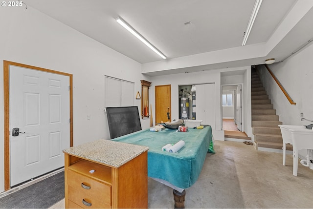 15263 Oceanview Dr, Brookings, OR 97415 - kitchen with electric water heater, concrete flooring, a kitchen island, and light stone countertops