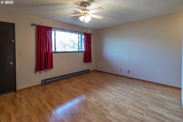 spare room with a textured ceiling, light wood finished floors, and a baseboard radiator