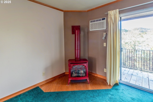 interior space featuring crown molding, a wood stove, an AC wall unit, wood finished floors, and baseboards