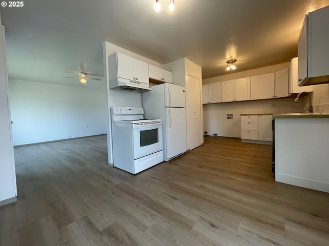 755735 Bluff Ave, Bandon, OR 97411 - kitchen with white appliances, a ceiling fan, under cabinet range hood, wood finished floors, and white cabinets