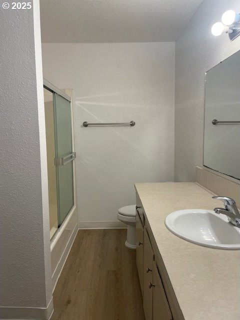 755735 Bluff Ave, Bandon, OR 97411 - full bath featuring wood finished floors, vanity, toilet, and baseboards