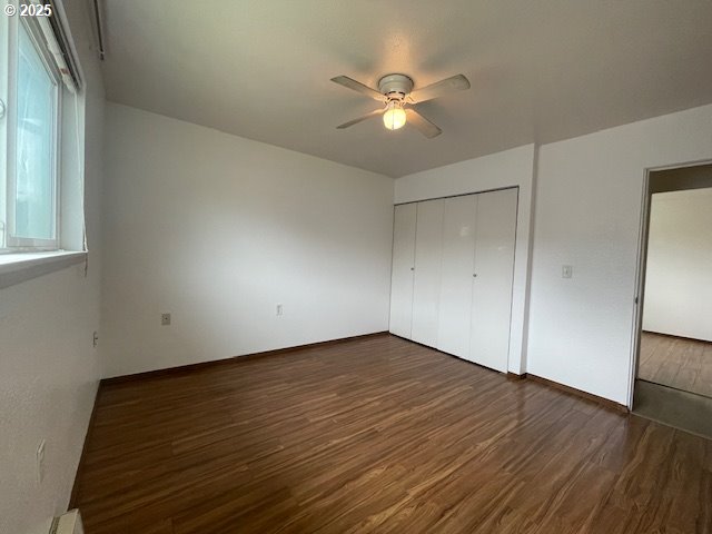 755735 Bluff Ave, Bandon, OR 97411 - unfurnished bedroom with wood finished floors, a closet, and ceiling fan