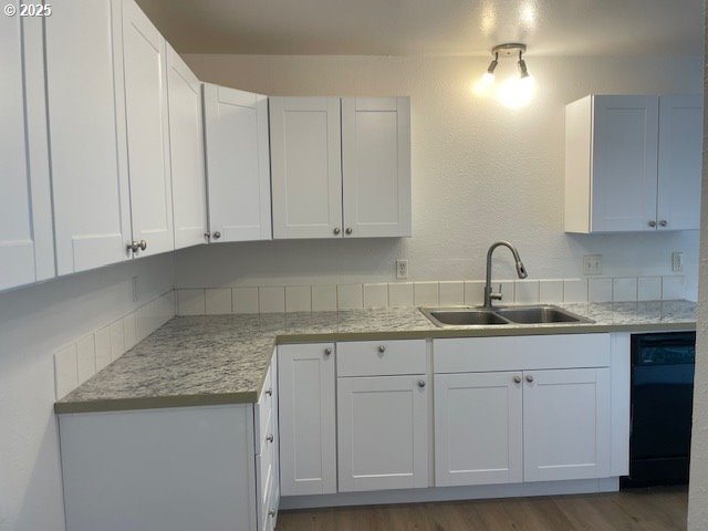 755735 Bluff Ave, Bandon, OR 97411 - kitchen with a sink, black dishwasher, light countertops, and white cabinetry