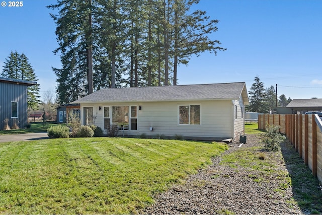 view of front of property with a front yard and fence