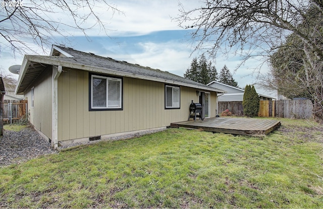 back of house featuring a yard and a deck