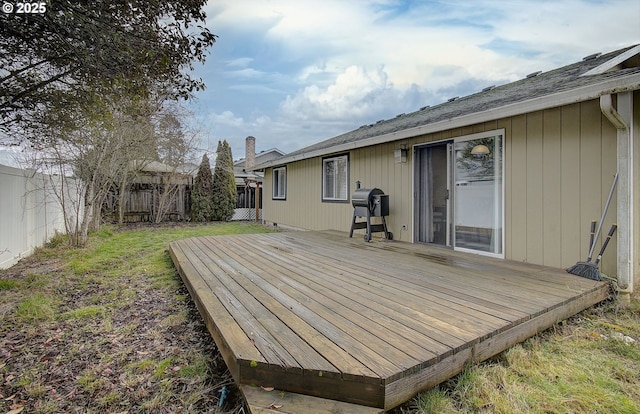 wooden terrace with area for grilling and a yard