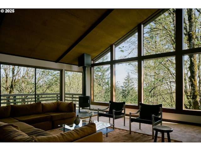 interior space featuring wooden ceiling, baseboards, carpet, and high vaulted ceiling