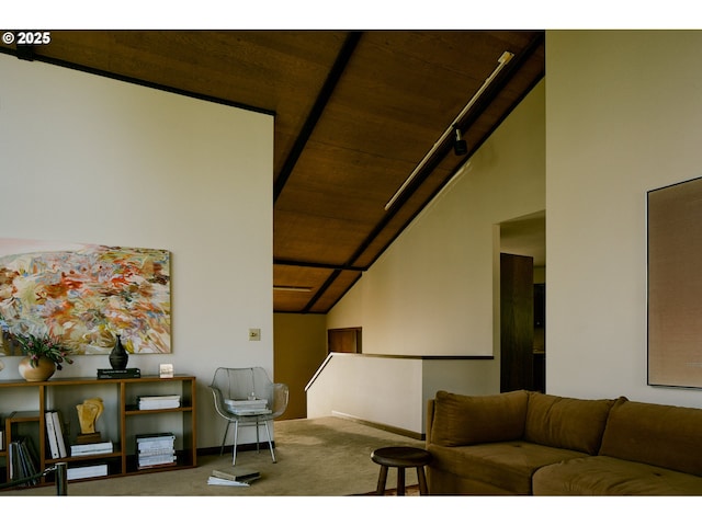 living area featuring carpet floors, baseboards, and lofted ceiling