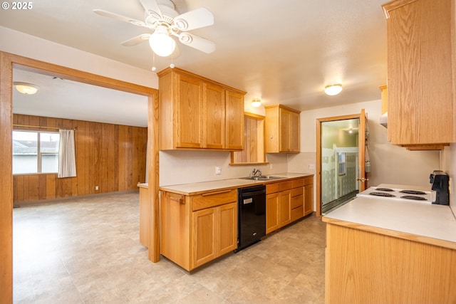 kitchen featuring ceiling fan, dishwasher, sink, and wood walls