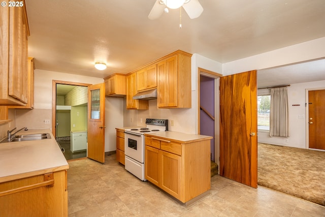 kitchen with electric stove, light colored carpet, ceiling fan, and sink