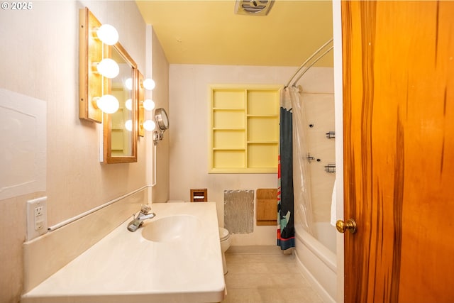 full bathroom with shower / tub combo, sink, tile patterned flooring, and toilet