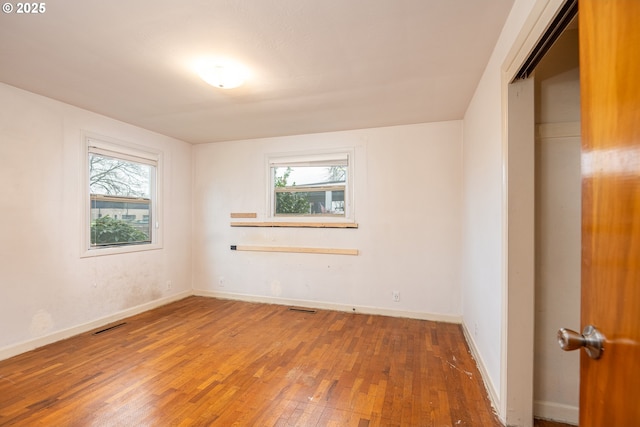 unfurnished room featuring hardwood / wood-style flooring