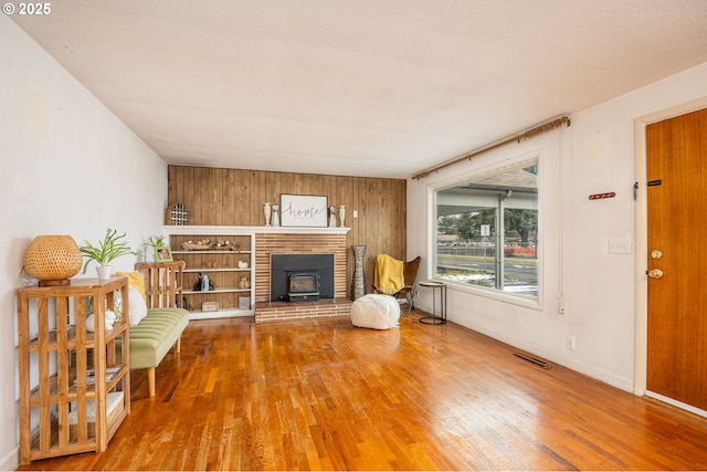 unfurnished room featuring hardwood / wood-style flooring and a textured ceiling