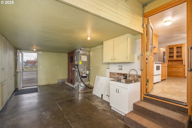 4160 Willhi St, Eugene, OR 97402 - kitchen with heating unit, white electric range oven, sink, a textured ceiling, and white cabinets