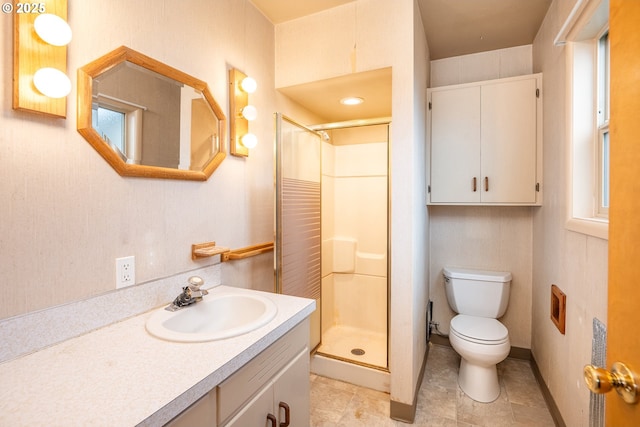 bathroom with vanity, toilet, and a shower