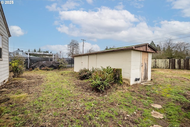 view of property exterior featuring a storage shed and a yard