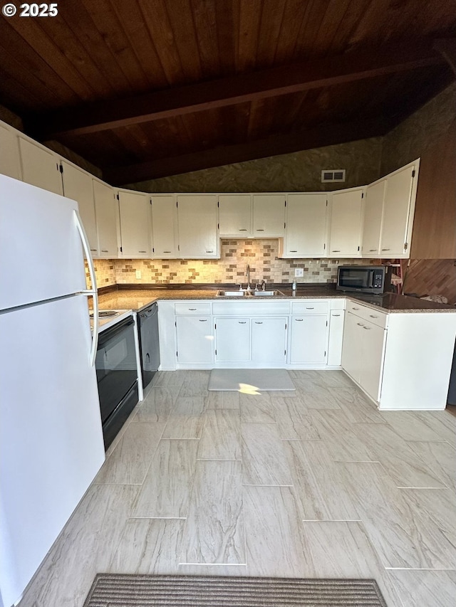 kitchen featuring tasteful backsplash, electric range, freestanding refrigerator, white cabinets, and a sink