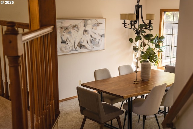 carpeted dining area with baseboards