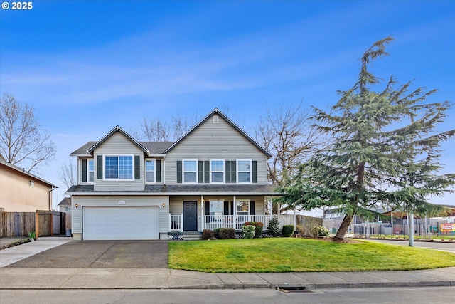 view of front of house featuring a porch, concrete driveway, an attached garage, a front yard, and fence