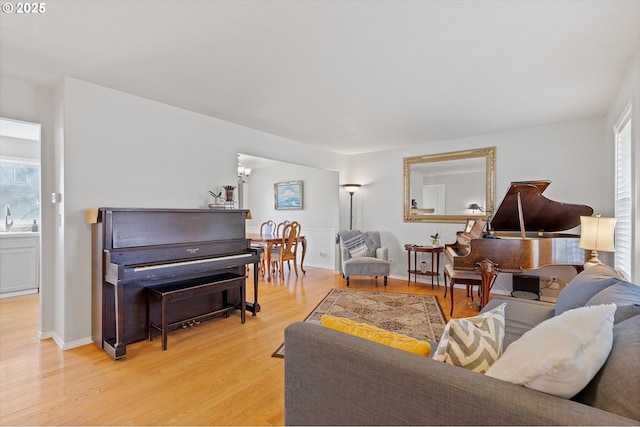 living room with baseboards and light wood-style floors