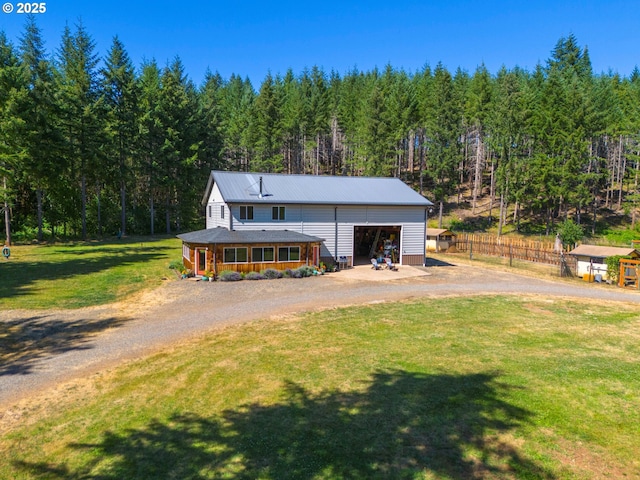 94986 Thetford Ln, Marcola, OR 97454 - view of front of property featuring a forest view, metal roof, dirt driveway, and a garage