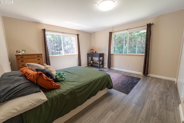 94986 Thetford Ln, Marcola, OR 97454 - bedroom with multiple windows, wood finished floors, and baseboards