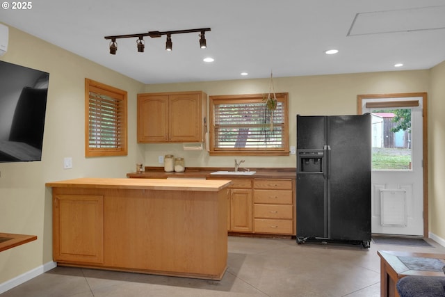 86680 Territorial Hwy, Veneta, OR 97487 - kitchen featuring black refrigerator with ice dispenser, wood counters, light brown cabinetry, a sink, and plenty of natural light