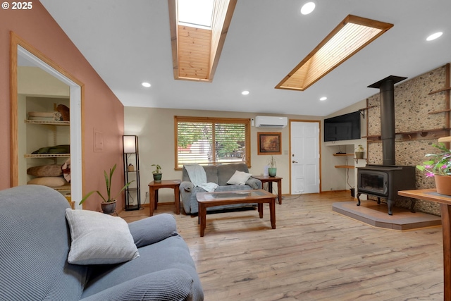 86680 Territorial Hwy, Veneta, OR 97487 - living area featuring a wall mounted AC, a wood stove, light wood-type flooring, vaulted ceiling, and recessed lighting