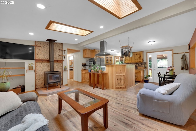 86680 Territorial Hwy, Veneta, OR 97487 - living room with a skylight, a wood stove, light wood-type flooring, and recessed lighting