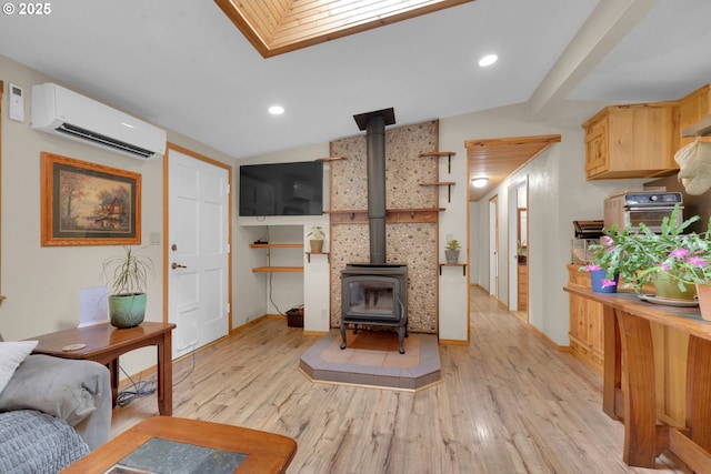 86680 Territorial Hwy, Veneta, OR 97487 - living room featuring a wall mounted air conditioner, a wood stove, light wood-type flooring, recessed lighting, and baseboards