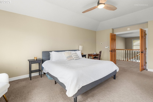 bedroom featuring lofted ceiling, ceiling fan, baseboards, and light colored carpet