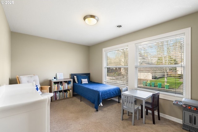 bedroom with visible vents, light carpet, and baseboards