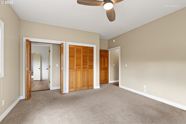 unfurnished bedroom with ceiling fan, carpet, and baseboards