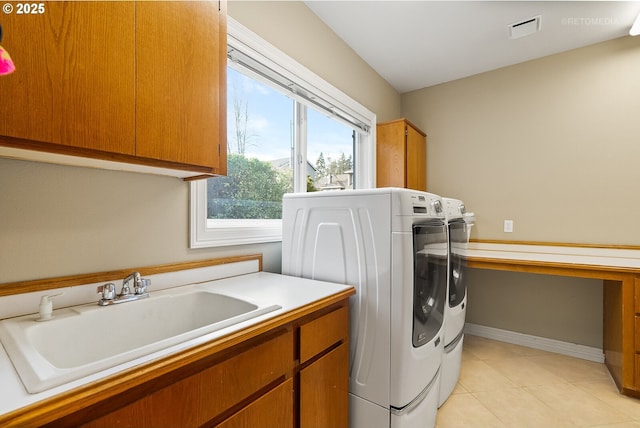 clothes washing area with cabinet space, light tile patterned floors, visible vents, independent washer and dryer, and a sink