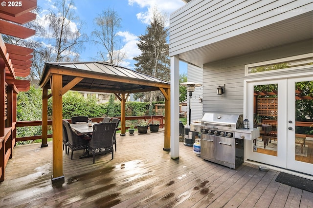 wooden deck with a gazebo, french doors, outdoor dining area, and grilling area