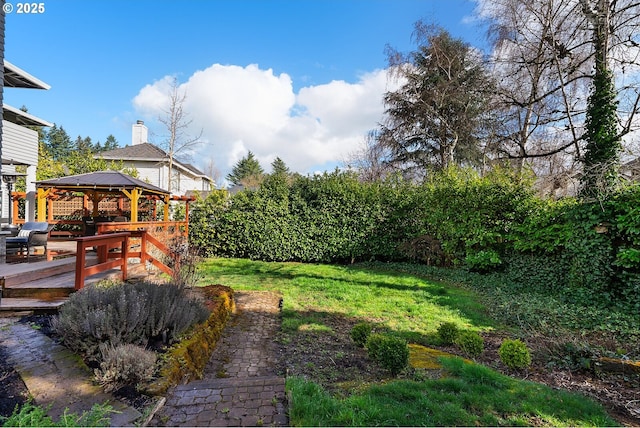 view of yard featuring a wooden deck and a gazebo