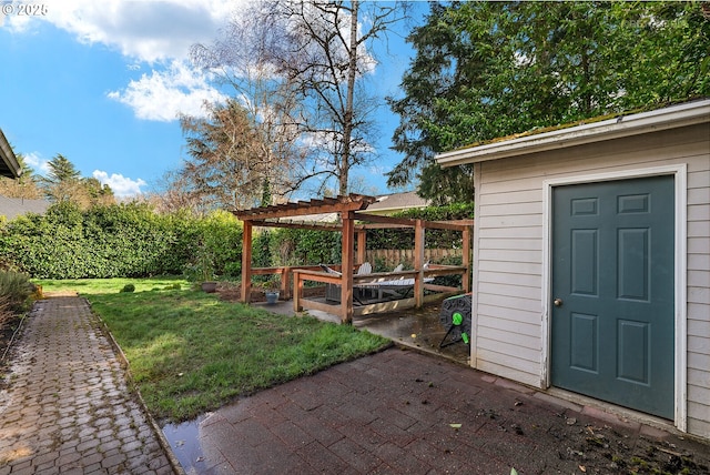 view of yard with a patio area, fence, an outdoor structure, and a pergola