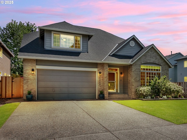 traditional-style home featuring brick siding, concrete driveway, a shingled roof, and an attached garage
