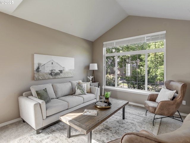 living area featuring vaulted ceiling, baseboards, and carpet floors