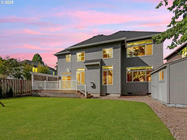 rear view of property with a wooden deck and an outbuilding