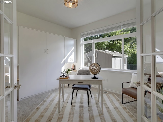 office featuring light colored carpet, baseboards, and french doors