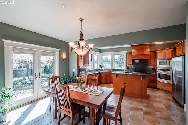 1603 Berkeley Ln, Monmouth, OR 97361 - dining area with healthy amount of natural light, a chandelier, french doors, and light tile patterned floors